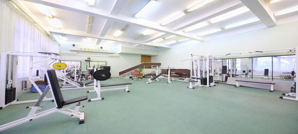 Spacious well lit empty gym with special equipment for physical training